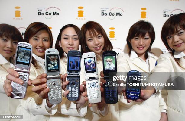 Models from NTT DoCoMo show off the company's latest 505i series mobile phones, F505i, P505i, N505i, D505i, SH505i and SO505i, during a press preview...