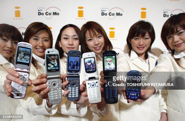 Models from NTT DoCoMo show off the company's latest 505i series mobile phones, F505i, P505i, N505i, D505i, SH505i and SO505i, during a press preview...