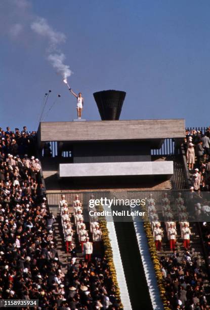 Summer Olympics: View of runner and flame torchbearer Japan Yoshinori Sakai lighting the Olympic cauldron during ceremony at Olympic Stadium....