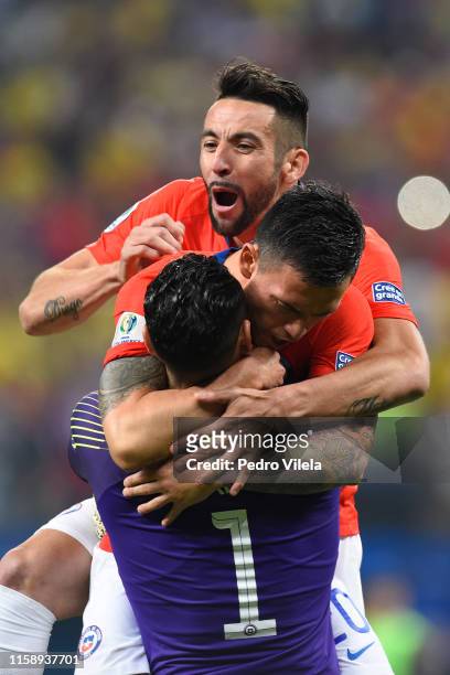 Gabriel Arias of Chile celebrates winning with teammates Mauricio Isla and Charles Aranguiz in a penalty shootout after the Copa America Brazil 2019...