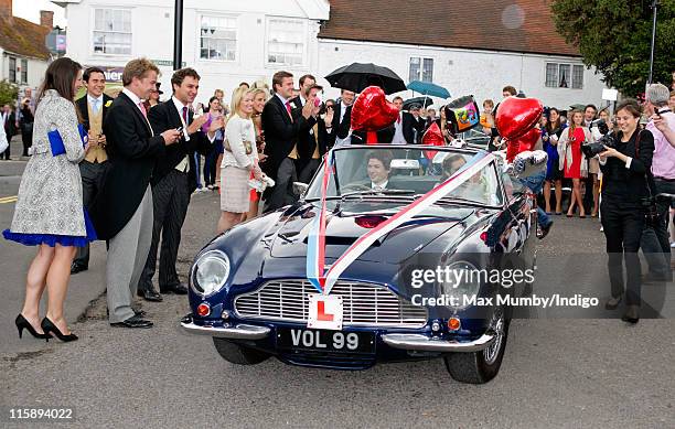 Sam Waley-Cohen and Annabel Ballin leave their wedding in a convertible Aston Martin car decorated with ribbons & balloons after their wedding at St....