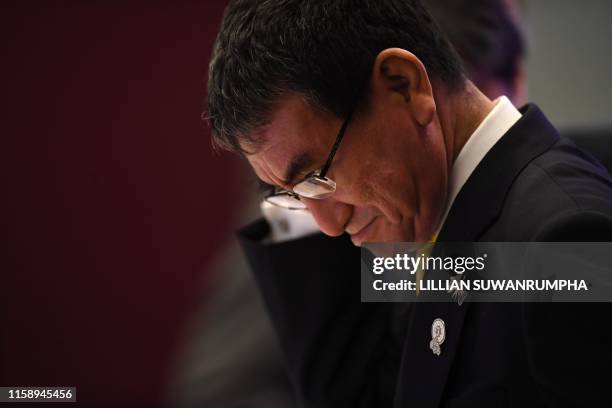 Japan's Foreign Minister Taro Kono arrives for the Association of Southeast Asian Nations Plus Three Foreign Ministers' Meeting in Bangkok on August...