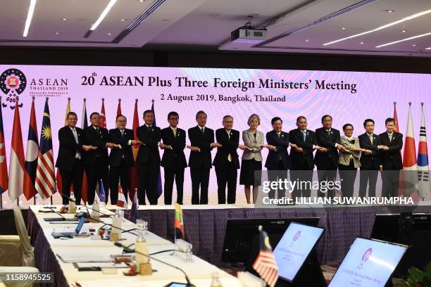 Japan's Foreign Minister Taro Kono , China's Foreign Minister Wang Yi and South Korea's Foreign Minister Kang Kyung-wha pose for a family photo...