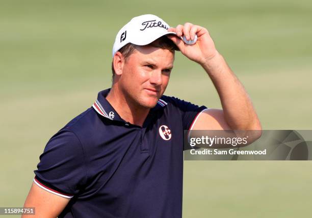 Robert Karlsson of Sweden raises his cap after a bogey on the 18th hole during the third round of the FedEx St. Jude Classic at TPC Southwind on June...