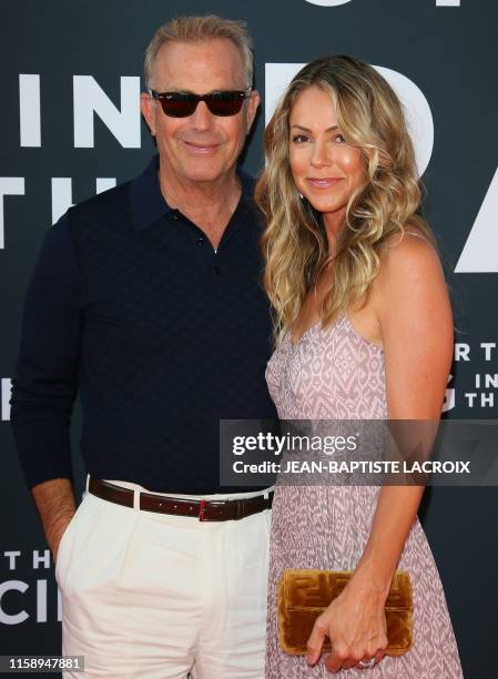 Actor Kevin Costner and wife US model Christine Baumgartner attend the premiere of 20th Century Fox's "The Art Of Racing In The Rain" at the El...