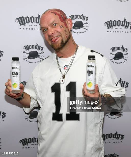 Singer Ivan Moody of Five Finger Death Punch displays CBD water bottles during an appearance to celebrate the release of Moody's Medicinals, his new...