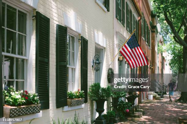 brick townhouses - american flag house stock pictures, royalty-free photos & images