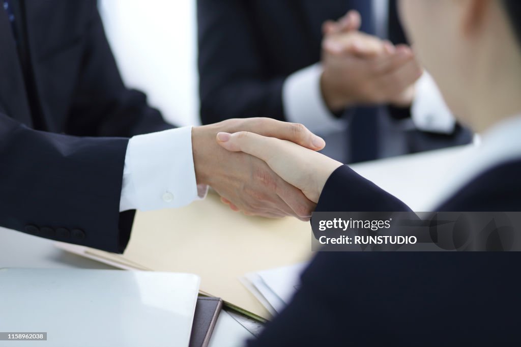 Business people shaking hands in meeting