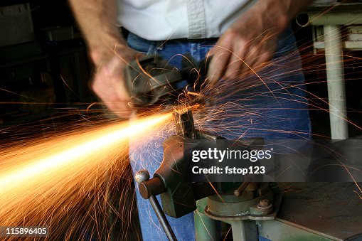 Caucasian Man Grinding in a workshop. Caucasian Man Grinding in a workshop.