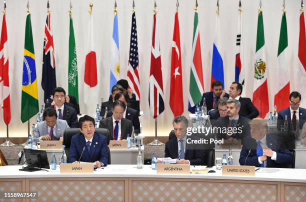 Shinzo Abe, Japan's prime minister speaks next to Argentina's president Mauricio Macri , and US President Donald Trump during the session 3 on...