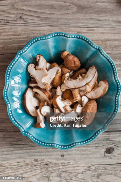 chopped shiitake mushrooms on a rustic wooden table - shiitake mushroom stock pictures, royalty-free photos & images