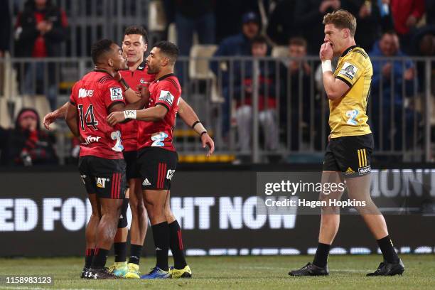 Sevu Reece of the Crusaders celebrates with Richie Mo’unga and David Havili after scoring a try during the Super Rugby Semi Final between the...