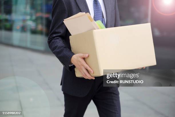 close-up of unemployed businessperson carrying cardboard box - being fired photos stock pictures, royalty-free photos & images