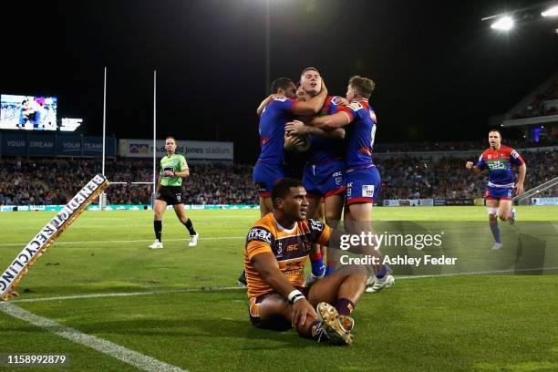 Shaun Kenny-Dowall of the Newcastle Knights celebrates his try with team mates during the round 15 NRL match between the Newcastle Knights and the...