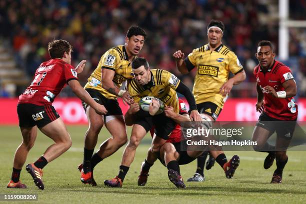James Marshall of the Hurricanes is tackled by Braydon Ennor of the Crusaders during the Super Rugby Semi Final between the Crusaders and the...