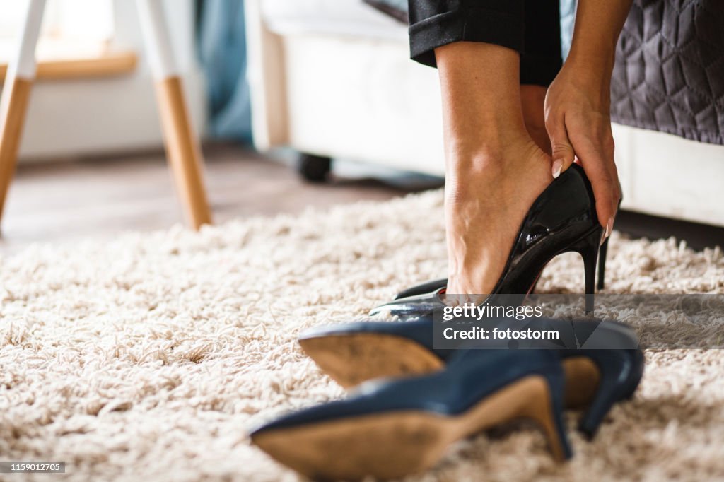Putting On High Heels While Getting Ready For Work High-Res Stock