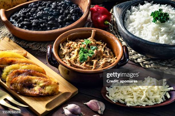 venezuelan traditional food, pabellon criollo with arepas, casabe and papelon with lemon drink - pabellon criollo stock pictures, royalty-free photos & images