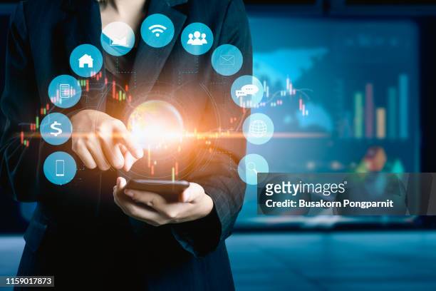 businesswomen using mobile phone analyzing data and economic growth graph chart. technology digital marketing and network connection. - solucion fotografías e imágenes de stock