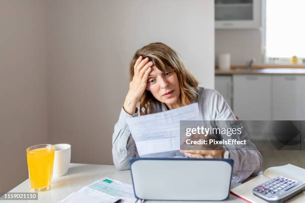 senior woman calculating domestic expenses - bad day stock pictures, royalty-free photos & images