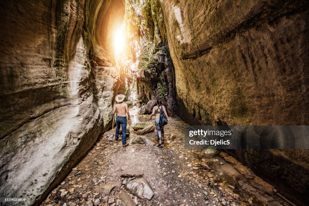 Hipster couple exploring a beautiful canyon on Cyprus island.