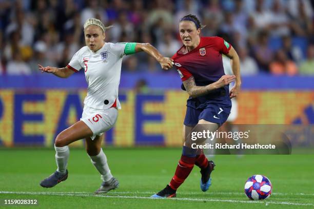 Steph Houghton of England battles with Isabell Herlovsen of Norway during the 2019 FIFA Women's World Cup France Quarter Final match between Norway...