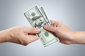 Hands sharing dollars
