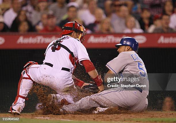 Catcher Jeff Mathis of the Los Angeles Angels of Anaheim tags out Melky Cabrera of the Kansas City Royals on a throw from Torii Hunter in the seventh...