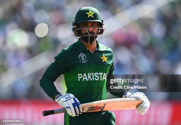Mohammad Hafeez of Pakistan walks off having been dismissed off the bowling of Mujeeb Ur Rahman of Afghanistan during the Group Stage match of the...
