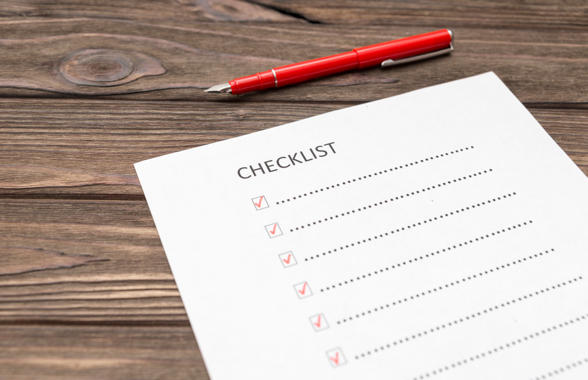 checklist, pen fountain pen, sheet of paper on a wooden background. scroll. checklist, pen fountain pen, sheet of paper on a wooden background. scroll.