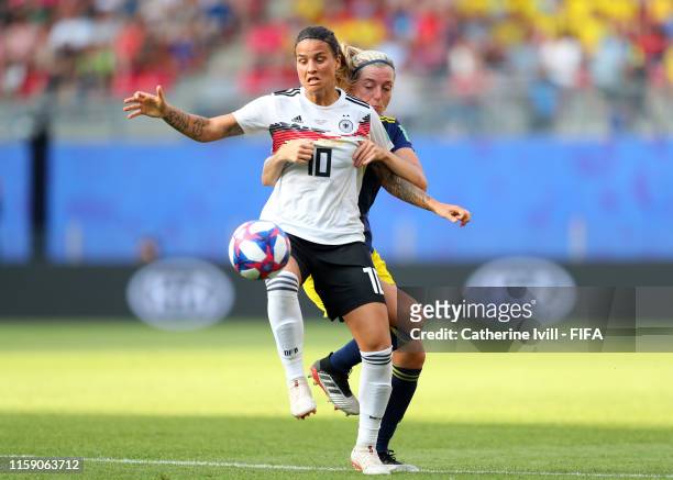 Dzsenifer Marozsan of Germany holds off Linda Sembrant of Sweden during the 2019 FIFA Women's World Cup France Quarter Final match between Germany...