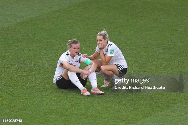 Alexandra Popp of Germany is consulted by teammate Lena Goessling of Germany at full-time after the 2019 FIFA Women's World Cup France Quarter Final...