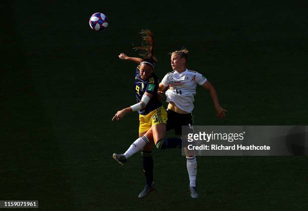 Kosovare Asllani of Sweden and Leonie Maier of Germany jump for the ball during the 2019 FIFA Women's World Cup France Quarter Final match between...