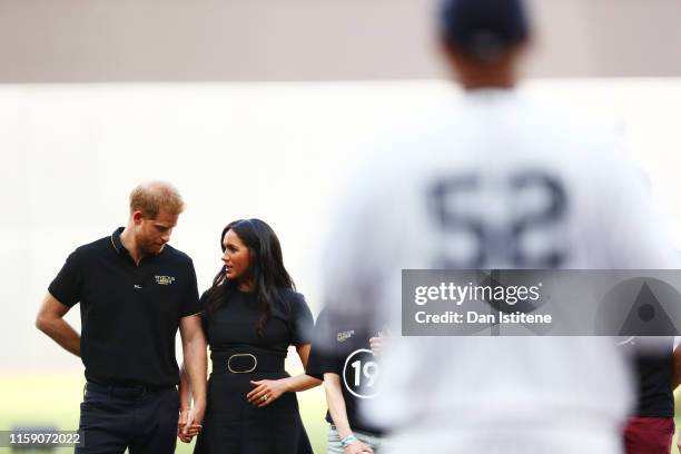 Prince Harry, Duke of Sussex and Meghan, Duchess of Sussex look on during the pre-game ceremonies before the MLB London Series game between Boston...