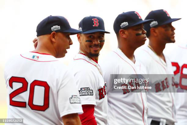 Mookie Betts of the Boston Red Sox speaks with manager Alex Cora of the Boston Red Sox before the MLB London Series game between Boston Red Sox and...