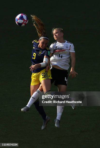 Kosovare Asllani of Sweden and Leonie Maier of Germany jump for the ball during the 2019 FIFA Women's World Cup France Quarter Final match between...