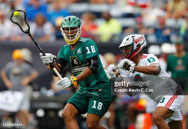 Kyle Harrison of Redwoods LC passes against Ty Warner of Whipsnakes LC during day two of the Premier Lacrosse League at Georgia State Stadium on June...