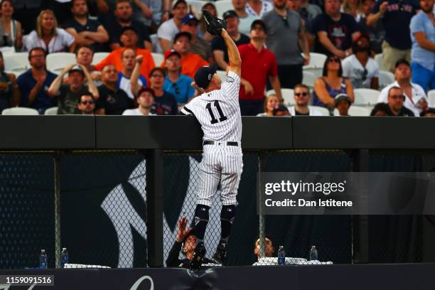 Brett Gardner of the New York Yankees stretches but fails to make a catch during the MLB London Series game between Boston Red Sox and New York...