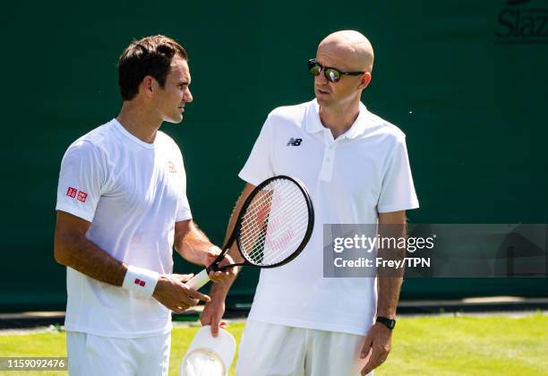 Roger Federer of Switzerland and his coach Ivan Ljubicic during a practice session before the start of The Championships - Wimbledon 2019 at All...