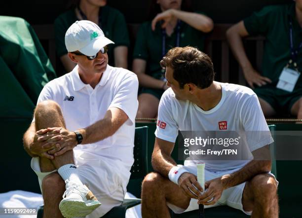 Roger Federer of Switzerland and his coach Ivan Ljubicic during a practice session before the start of The Championships - Wimbledon 2019 at All...