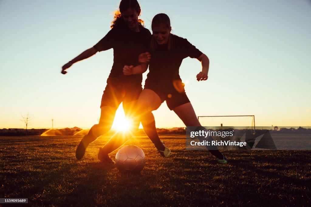 Female Soccer Players Battle for Ball