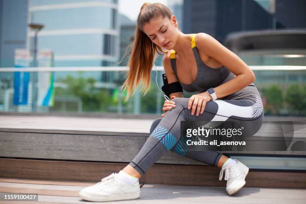 woman getting injured while training outdoors hong kong - injured knee stock pictures, royalty-free photos & images