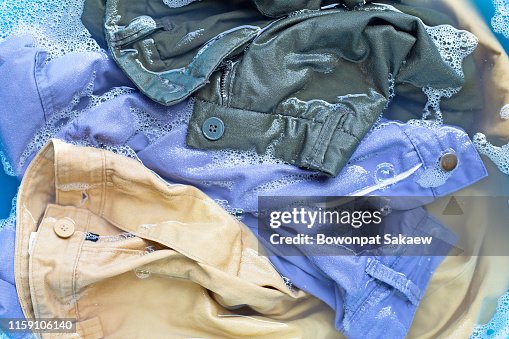 Trousers soak in powder detergent water dissolution. Laundry concept Trousers soak in powder detergent water dissolution. Laundry concept