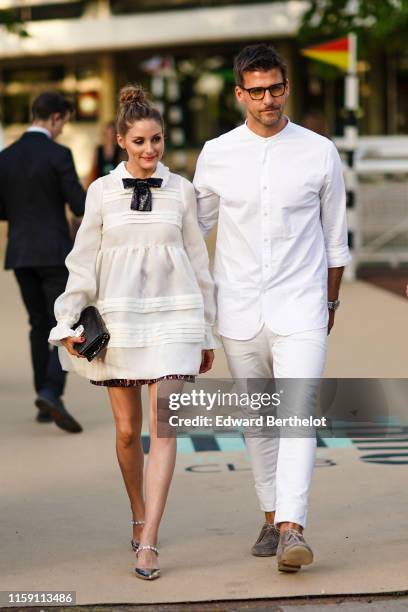 Olivia Palermo wears a white dress and a black sequined bow tie ; Johannes Huebl wears a white shirt, glasses, outside Miu Miu Club 2020, on June 29,...