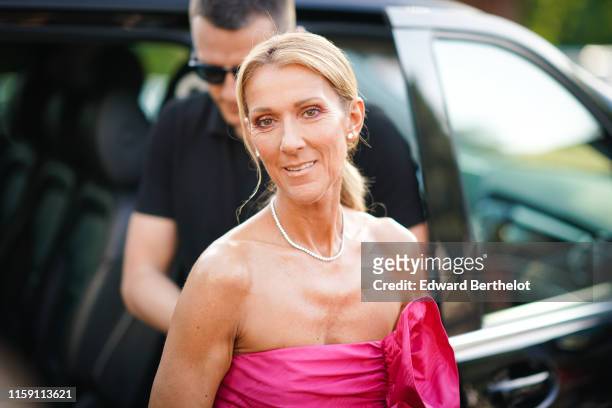 Celine Dion wears a pink ruffled dress, a necklace, earrings, outside Miu Miu Club 2020, on June 29, 2019 in Paris, France.