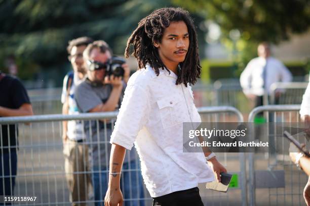 Luka Sabbat wears a white shirt, outside Miu Miu Club 2020, on June 29, 2019 in Paris, France.