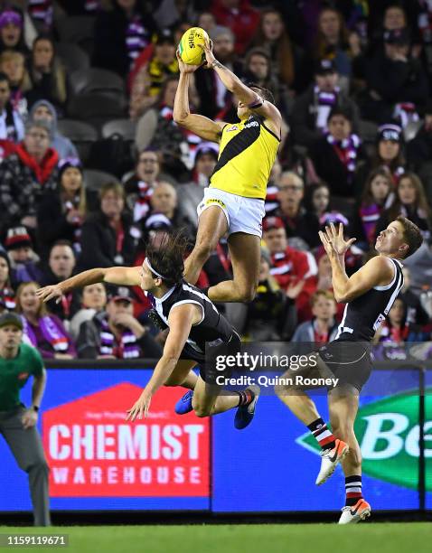 Sydney Stack of the Tigers marks over the top of Hunter Clark of the Saints during the round 15 AFL match between the St Kilda Saints and the...