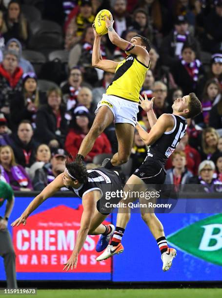 Sydney Stack of the Tigers marks over the top of Hunter Clark of the Saints during the round 15 AFL match between the St Kilda Saints and the...