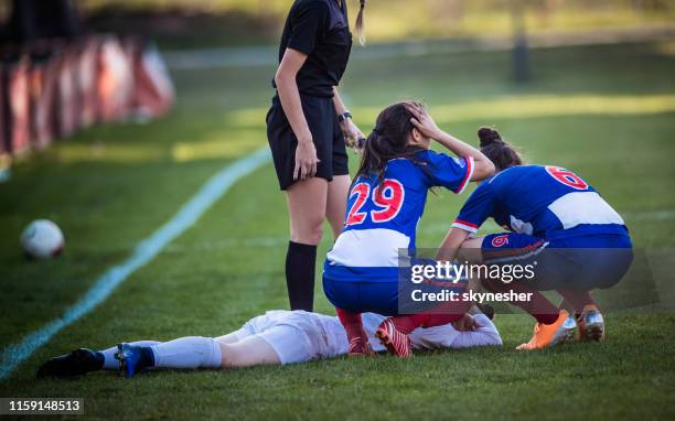 injury on women's soccer match! - injured football player stock pictures, royalty-free photos & images