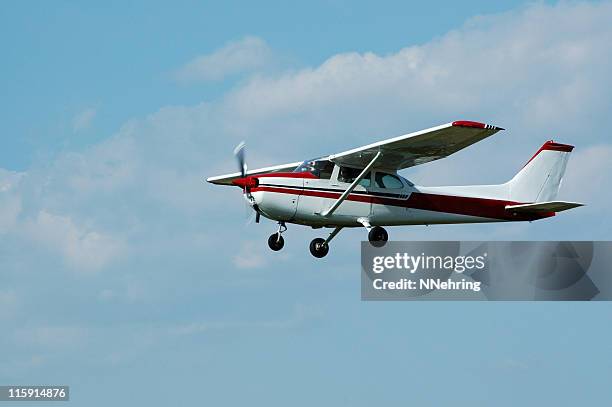 private airplane cessna 172 in blue sky with white clouds - small plane stock pictures, royalty-free photos & images