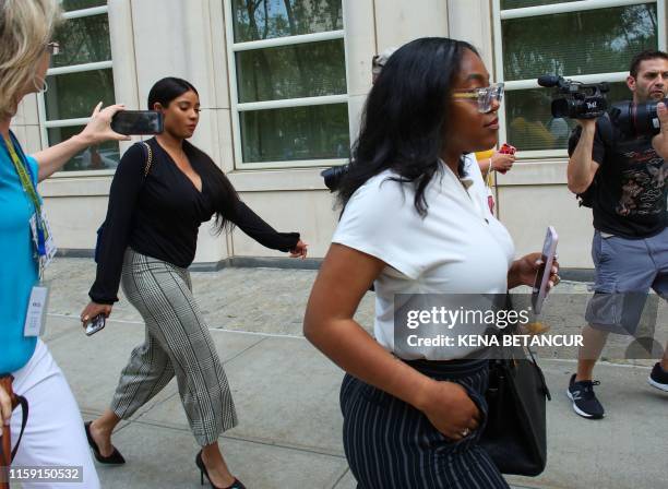 Kelly's girlfriends, Jocelyn Savage and Azriel Clary, leave after a hearing in the racketeering and sex trafficking case of Kelly at Brooklyn federal...